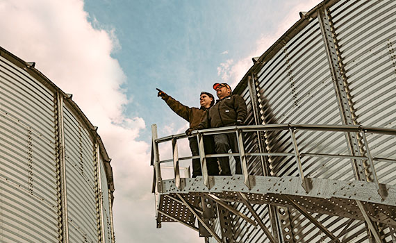 a man and woman at the top of a silo