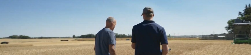 two men walking in a field