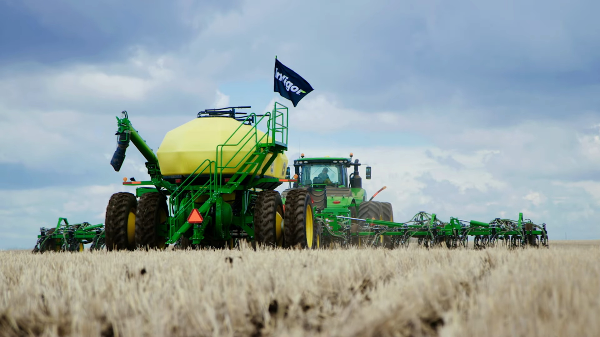 Tractor harvesting crops in field