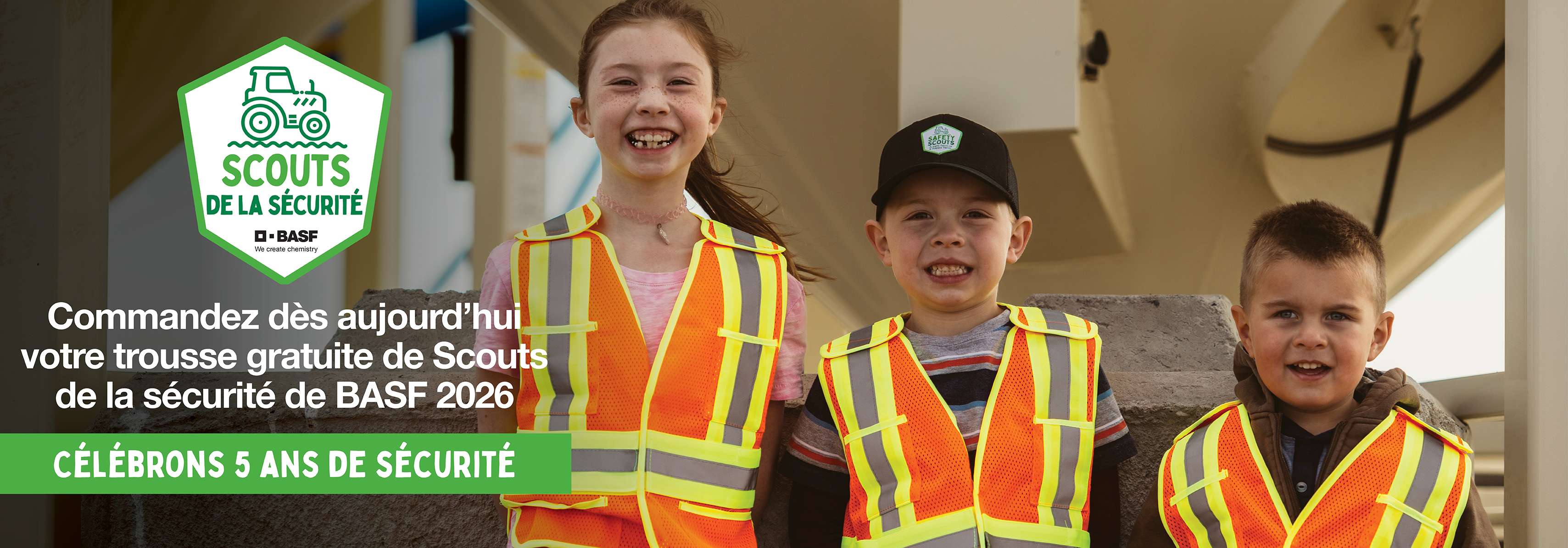 Children wearing orange safety vests and smiling