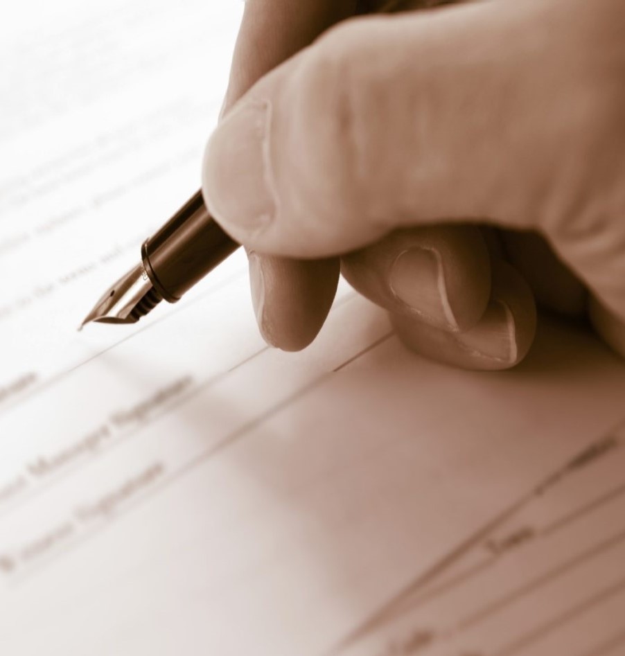 Close-up of an individual signing a document